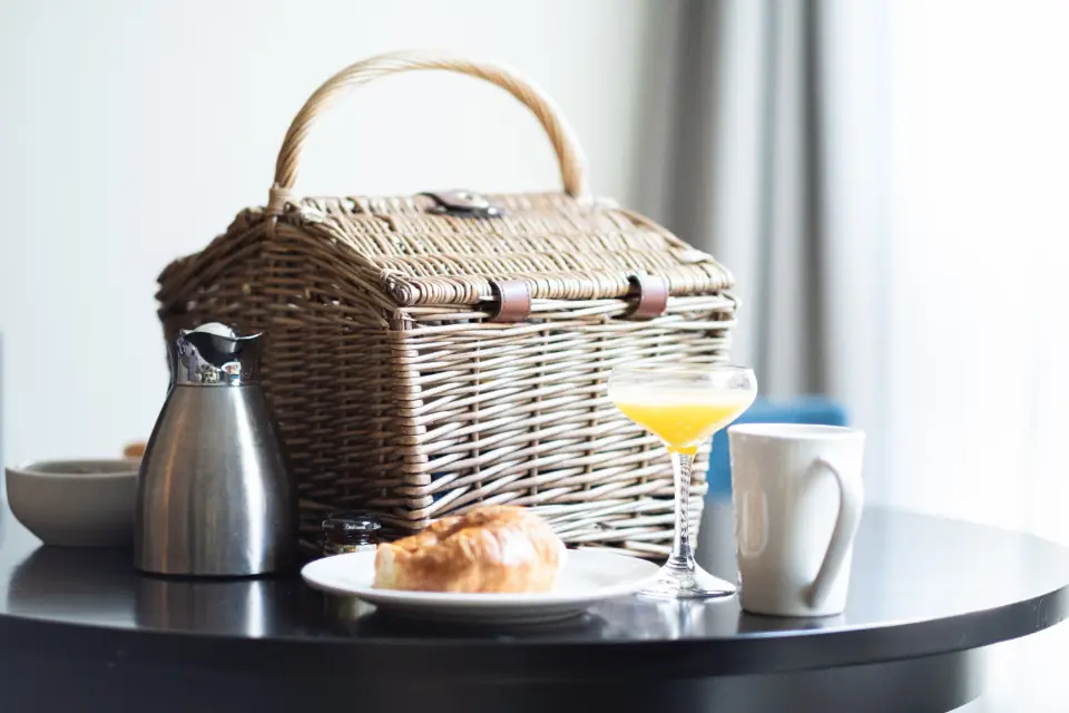 A hotel breakfast table with coffee, orange juice and a pastry